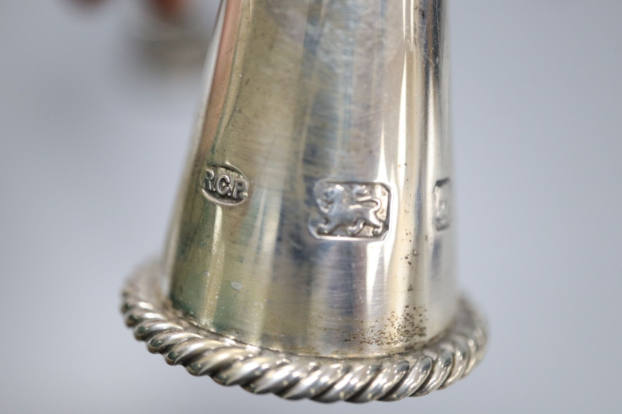 A modern silver table bell with putti handle, and a modern silver and turned wood handle candle snuffer,